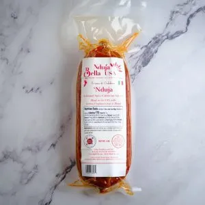 Nduja Bella spicy Calabrian spread sausage in clear packaging, ready for authentic Italian cuisine.