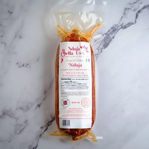 Nduja Bella spicy Calabrian spread sausage in clear packaging, ready for authentic Italian cuisine.